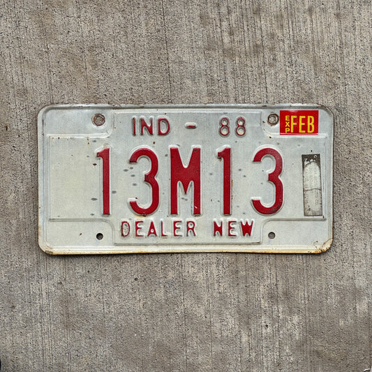 Photo of a 1988 Indiana Dealer License Plate Auto Tag Garage Decor Vintage New Car Dealer Nice Number 13 M 13 with original patina
