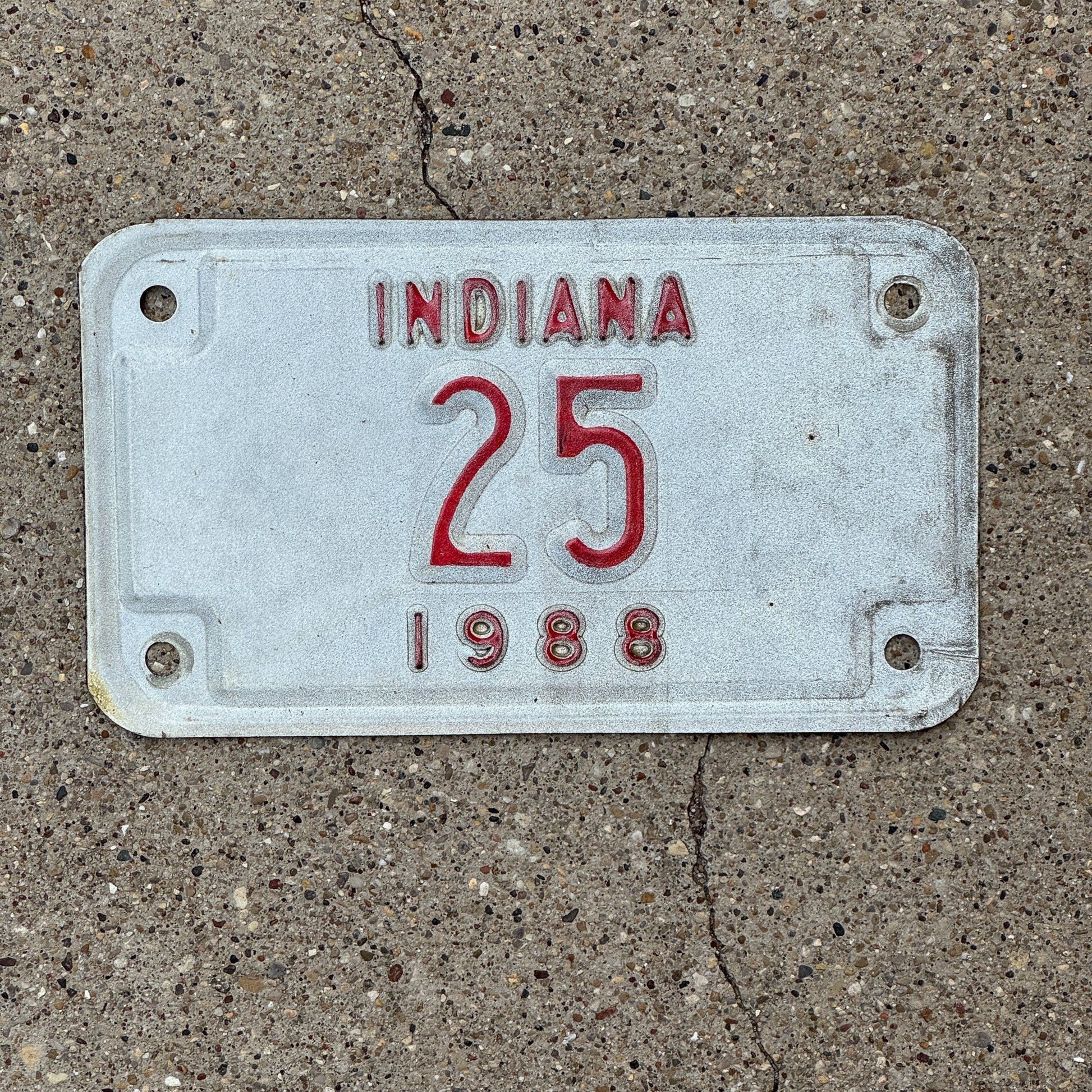 Photo of a 1988 Indiana Motorcycle License Plate Auto Tag Garage Decor Vintage Low Number Two Digit 25 with original patina