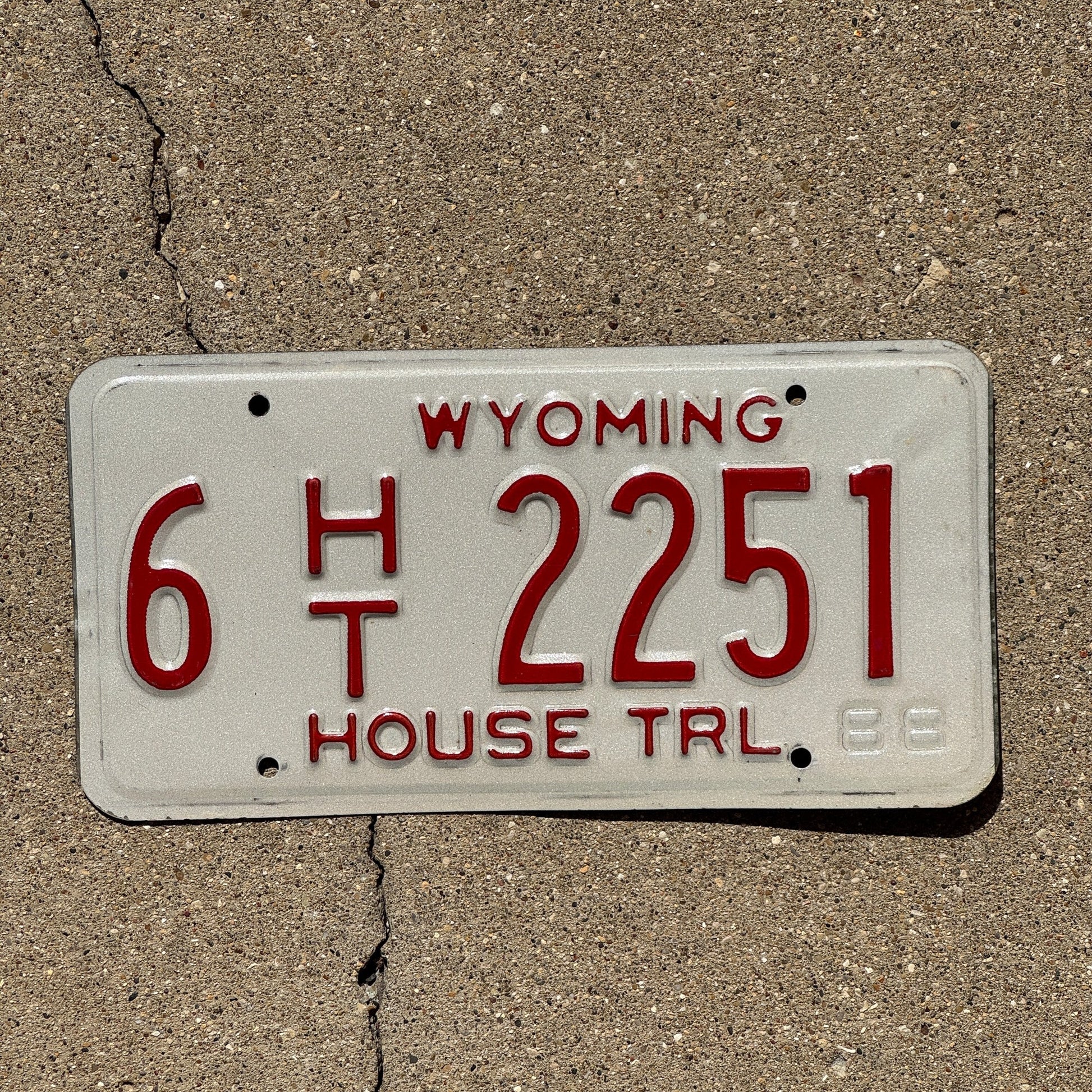 Photo of a 1989 Wyoming House Trailer License Plate Auto Tag Garage Decor Vintage 6 HT 2251