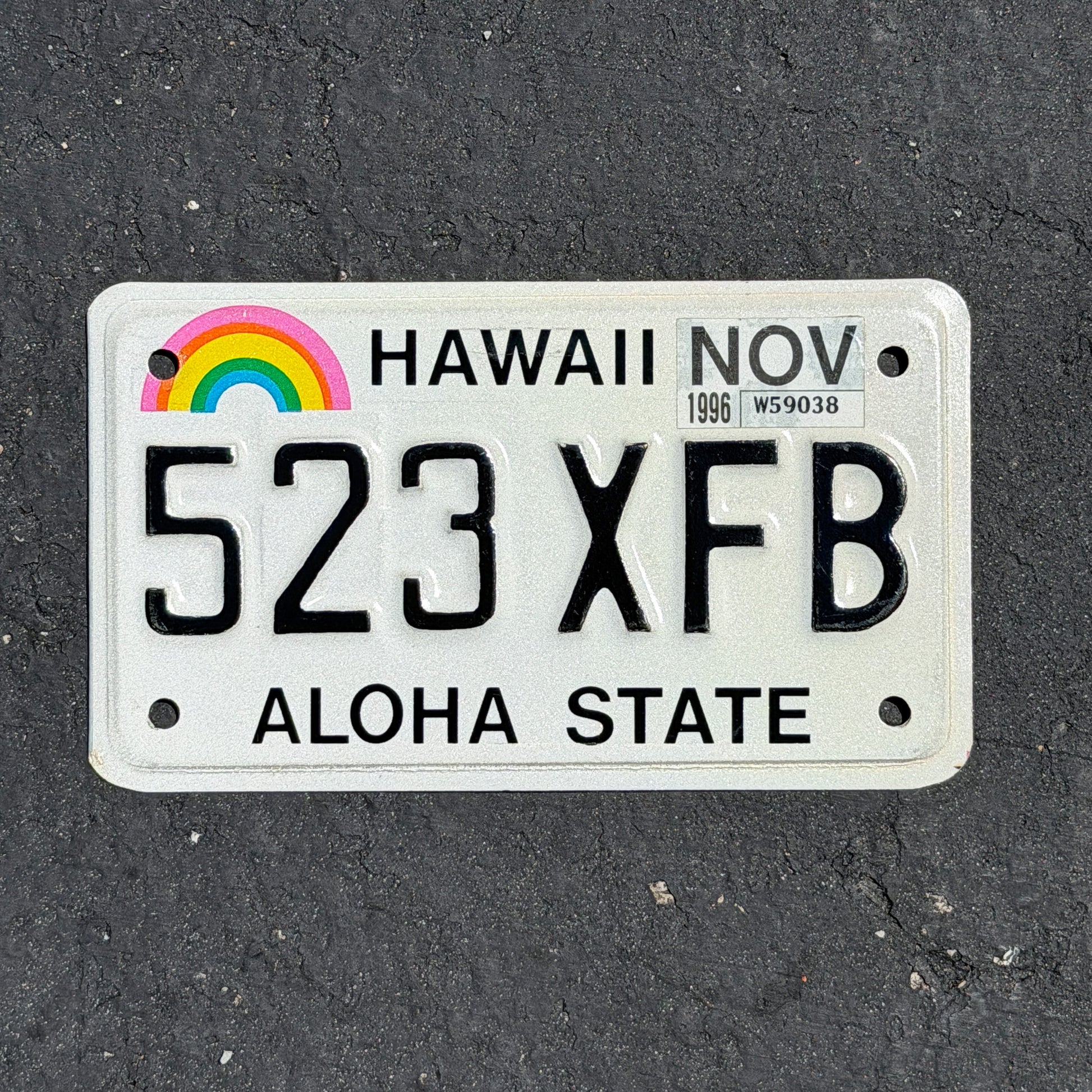 Photo of a 1990 1996 Hawaii Motorcycle License Plate Auto Tag Garage Decor Vintage Rainbow 523 XFB with original patina
