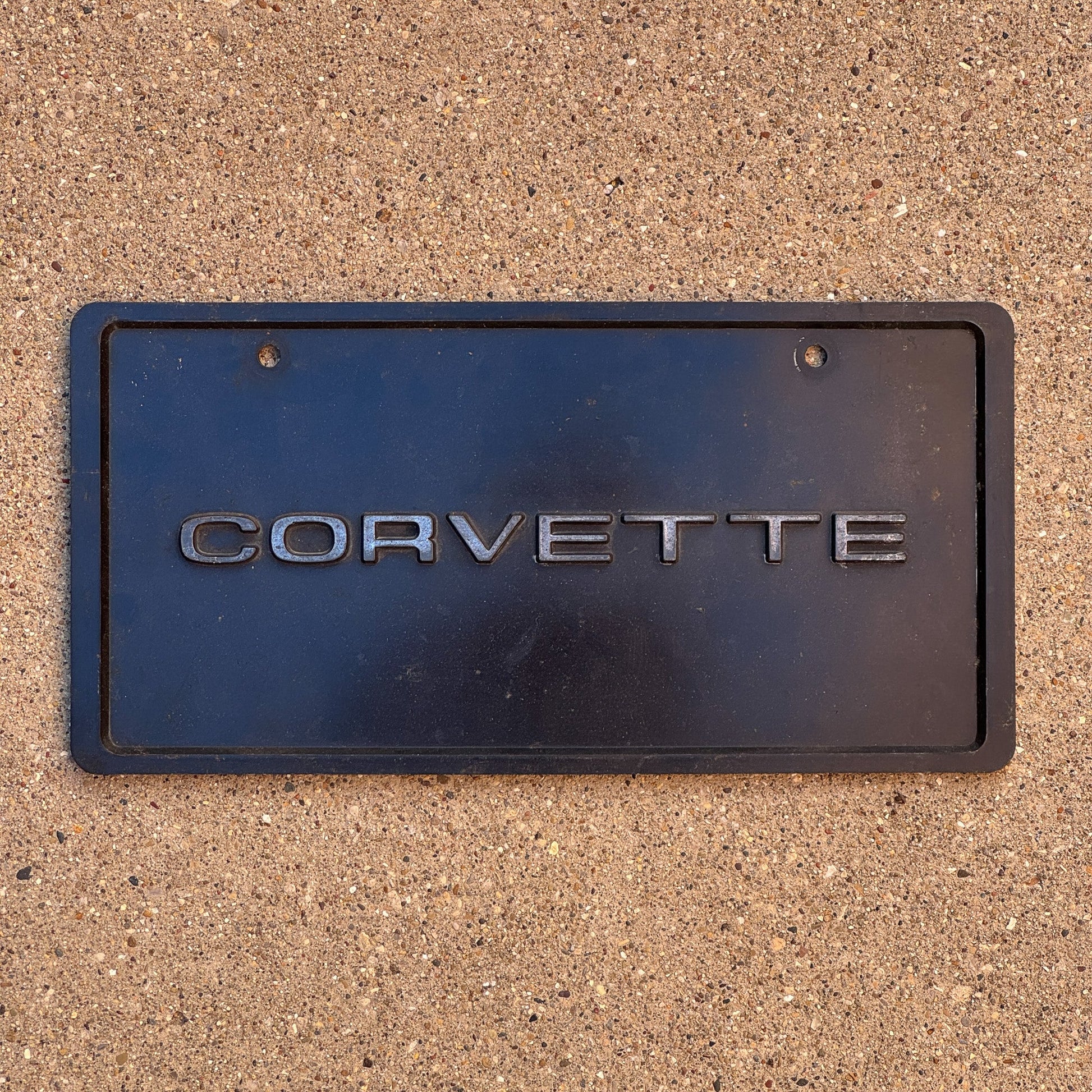 Photo of a 1990 Era Booster License Plate Auto Tag Garage Decor Vintage Plastic Corvette