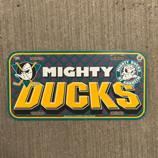 Photo of a 1990 Era California License Plate Booster License Plate Auto Tag Garage Decor Vintage Plastic Anaheim Hockey NHL Mighty Ducks with original patina