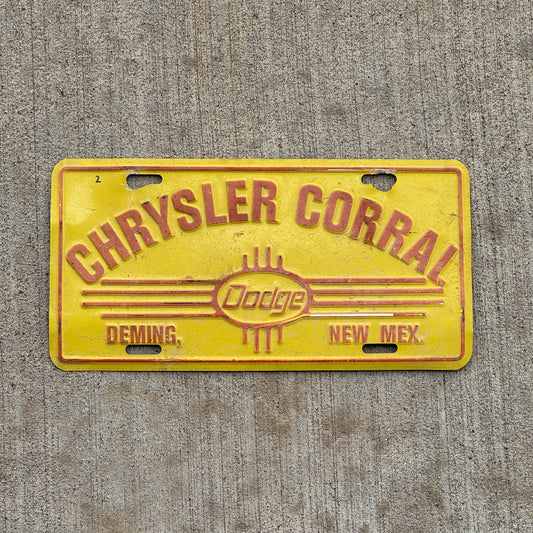 Photo of a 1990 Era Chrysler Corral Deming New Mexico Booster License Plate Auto Tag Garage Decor Vintage Dodge Metal with original patina