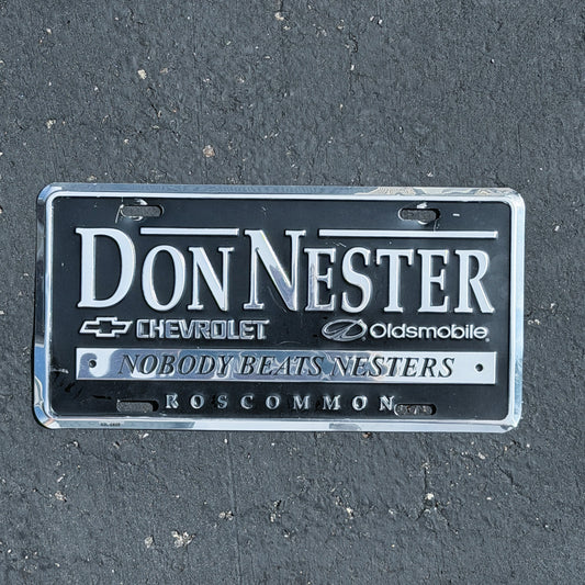 Photo of a 1990 Era Don Nester Nobody Beats Nesters Michigan Booster License Plate Auto Tag Garage Decor Vintage
 Chevrolet Oldsmobile Dealer Metal with original patina