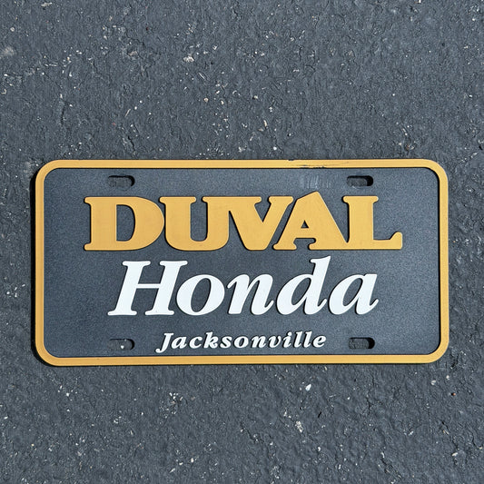 Photo of a 1990 Era Duval Florida Booster License Plate Auto Tag Garage Decor Vintage
 Honda Plastic with original patina