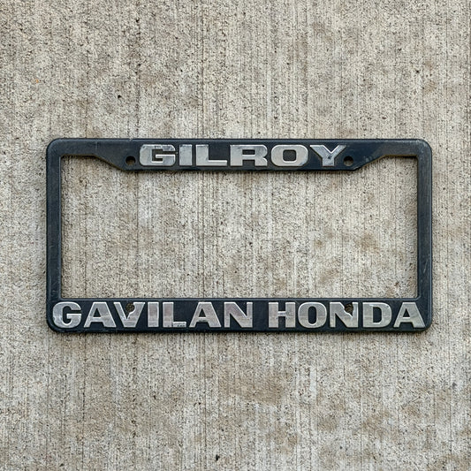 Photo of a 1990 Era Gilroy California Dealer License Plate Frame Auto Tag Garage Decor Vintage
 Plastic Gavilan Honda with original patina