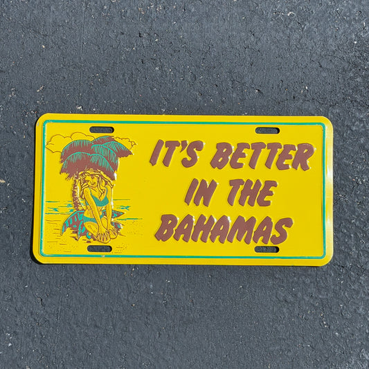 Photo of a 1990 Era It's Better in the Bahamas Bahamas Booster License Plate Auto Tag Garage Decor Vintage
 Palm Tree Tropics Beach Babe Metal with original patina
