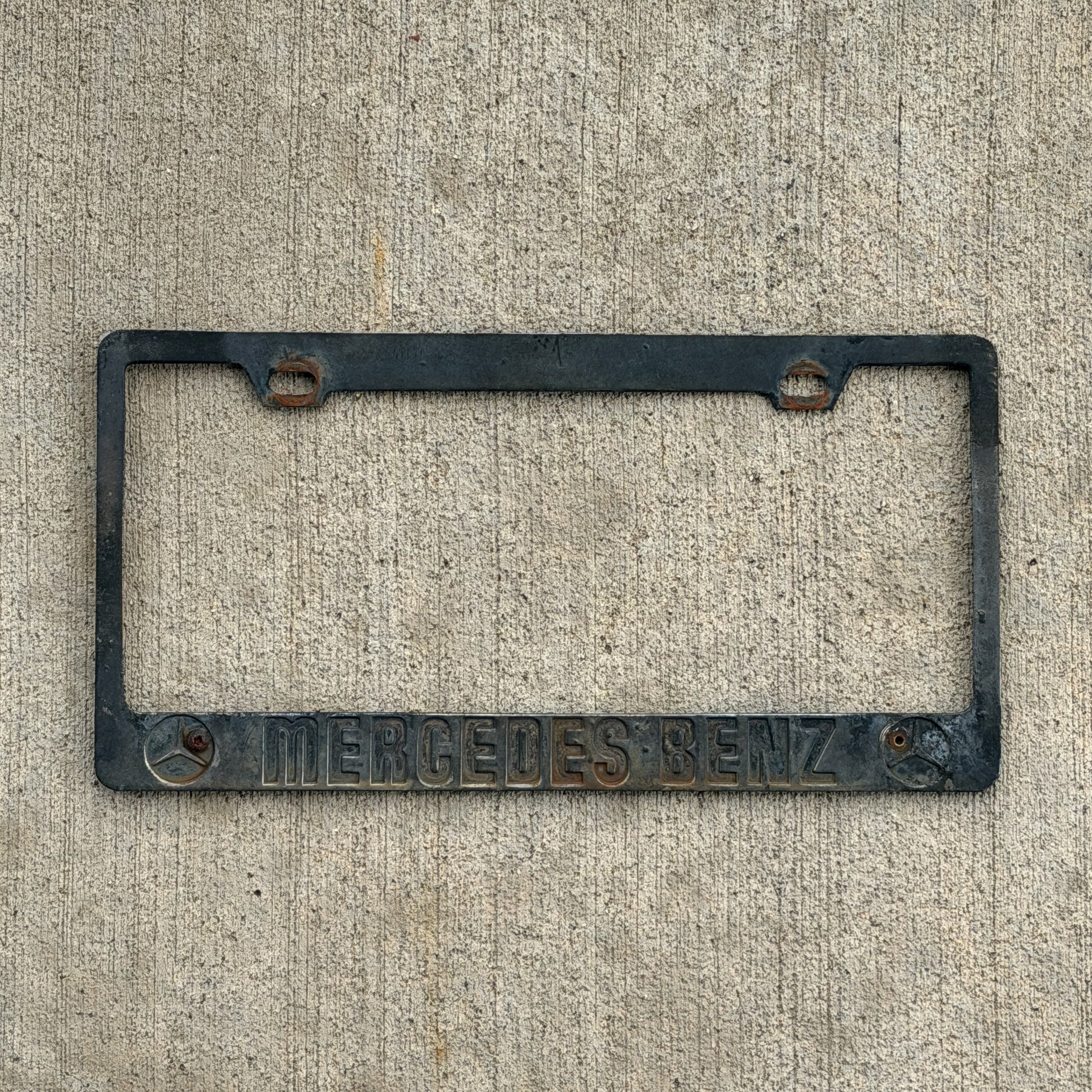 Photo of a 1990 Era License Plate Frame Auto Tag Garage Decor Vintage Mercedes Benz with original patina