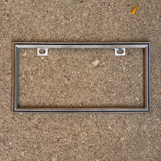 Photo of a 1990 Era License Plate Frame Auto Tag Garage Decor Vintage Plastic with original patina