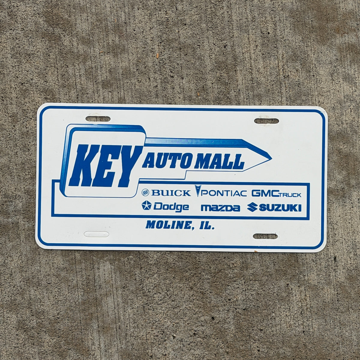 Photo of a 1990 Era Moline Illinois Booster License Plate Auto Tag Garage Decor Vintage Key Auto Mall Plastic with original patina