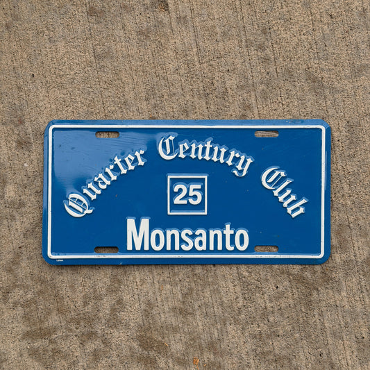 Photo of a 1990 Era Monsanto Quarter Century Club Booster License Plate Auto Tag Garage Decor Vintage Metal with original patina