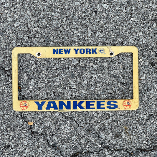 Photo of a 1990 Era New York License Plate Frame Auto Tag Garage Decor Vintage Plastic Yankees MLB