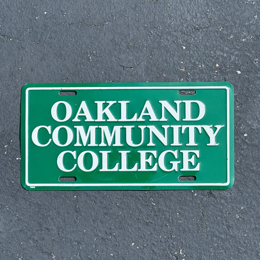 Photo of a 1990 Era Oakland Community College Michigan Booster License Plate Auto Tag Garage Decor Vintage
 Metal with original patina