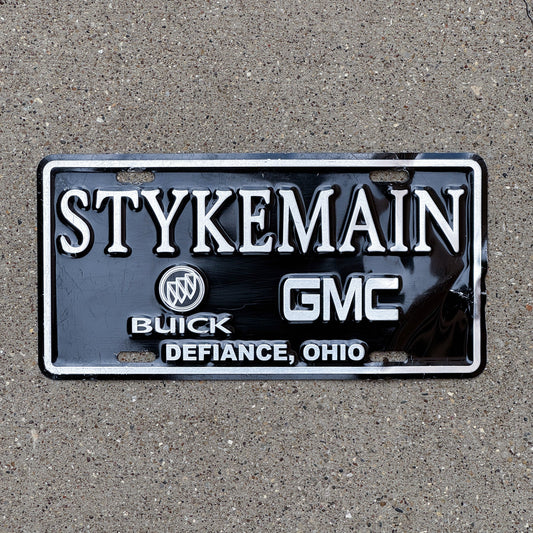 Photo of a 1990 Era Ohio Booster License Plate Auto Tag Garage Decor Vintage Buick GMC Dealer Stykeman Buick and GMC Defiance OH with original patina