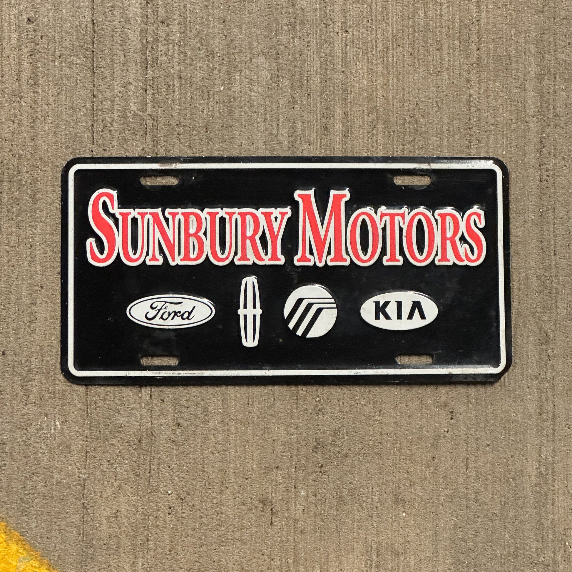 Photo of a 1990 Era Pennsylvania Booster License Plate Auto Tag Garage Decor Vintage Ford Kia Sunbury Motors with original patina