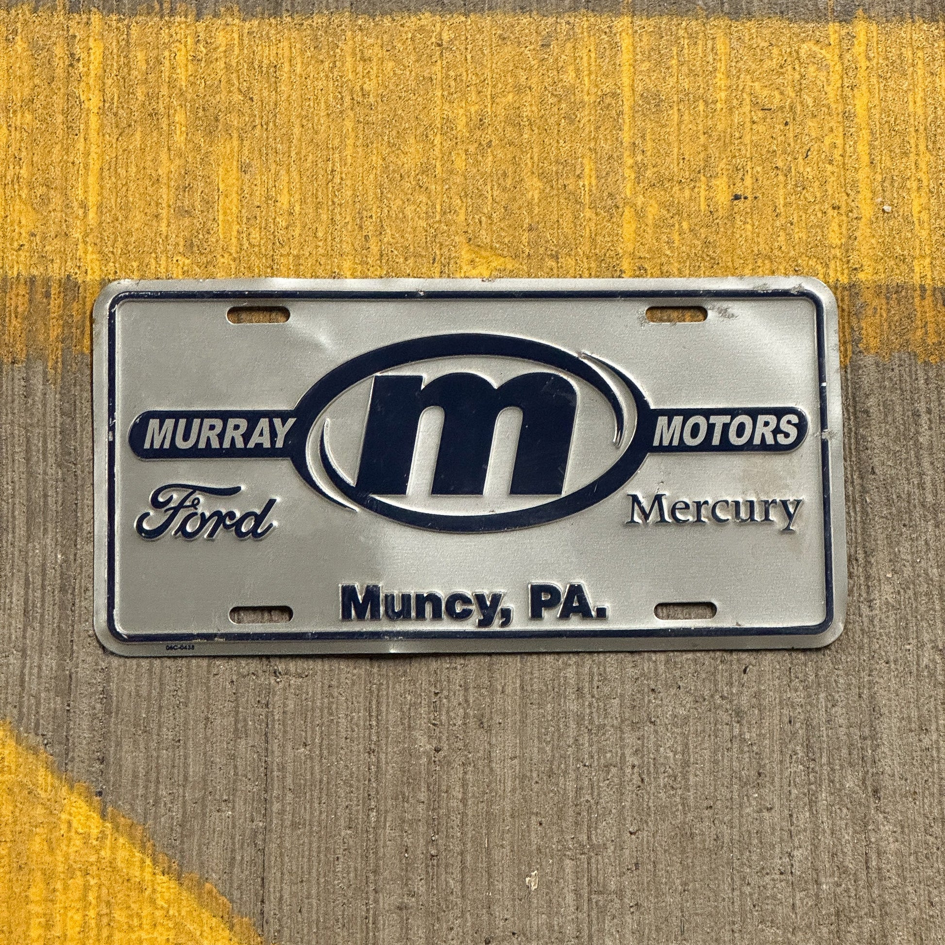 Photo of a 1990 Era Pennsylvania Booster License Plate Auto Tag Garage Decor Vintage Muncy Murray Motors Ford with original patina