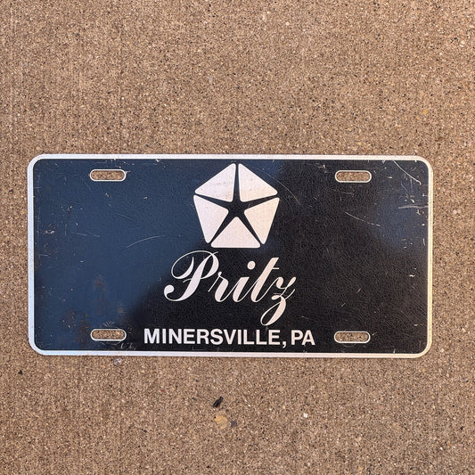 Photo of a 1990 Era Pennsylvania License Plate Booster License Plate Auto Tag Garage Decor Vintage Minersville Metal Pritz Dodge Chrysler with original patina