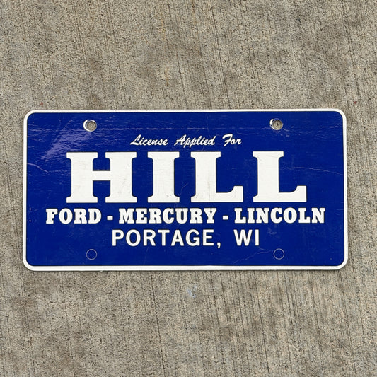 Photo of a 1990 Era Portage Wisconsin Booster License Plate Auto Tag Garage Decor Vintage Hill Ford Mercury Lincoln Paper with original patina