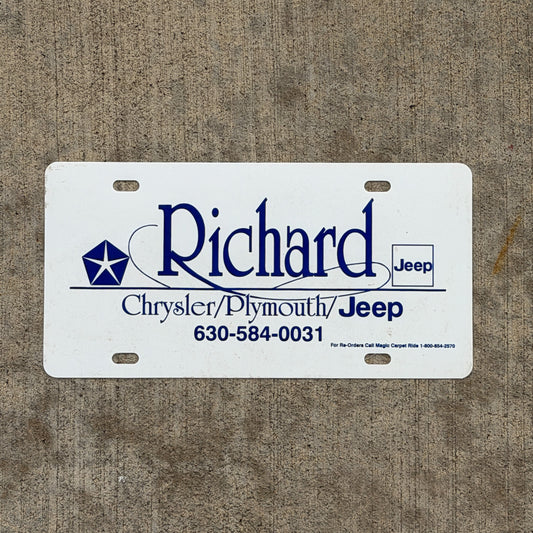 Photo of a 1990 Era Richard Chrysler Plymouth Jeep Booster License Plate Auto Tag Garage Decor Vintage Plastic with original patina
