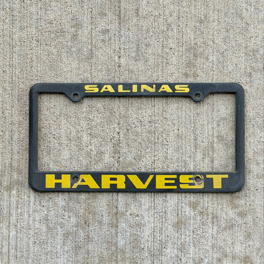Photo of a 1990 Era Salinas California Dealer License Plate Frame Auto Tag Garage Decor Vintage
 Plastic Harvest Buick Pontiac GMC with original patina