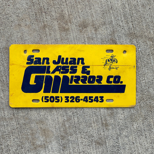 Photo of a 1990 Era San Juan Glass Mirror Co New Mexico Booster License Plate Auto Tag Garage Decor Vintage Flimsy Plastic with original patina