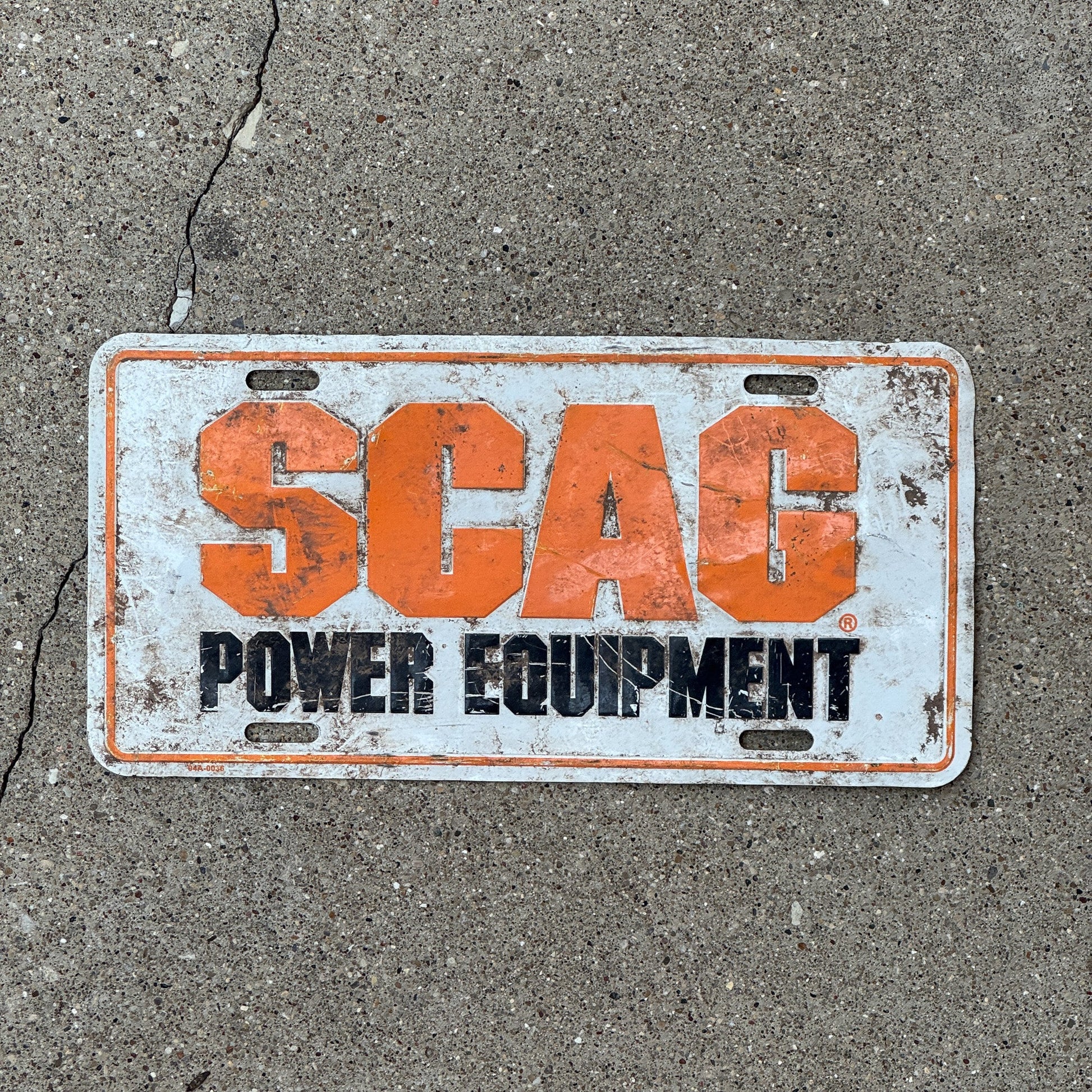 Photo of a 1990 Era Unnamed record Booster License Plate Auto Tag Garage Decor Vintage SCAG Power Equipment