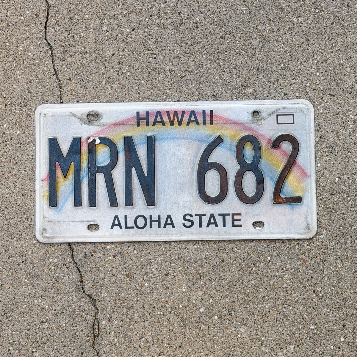 Photo of a 1990 Hawaii License Plate Auto Tag Garage Decor Vintage Rainbow MRN 682 with original patina