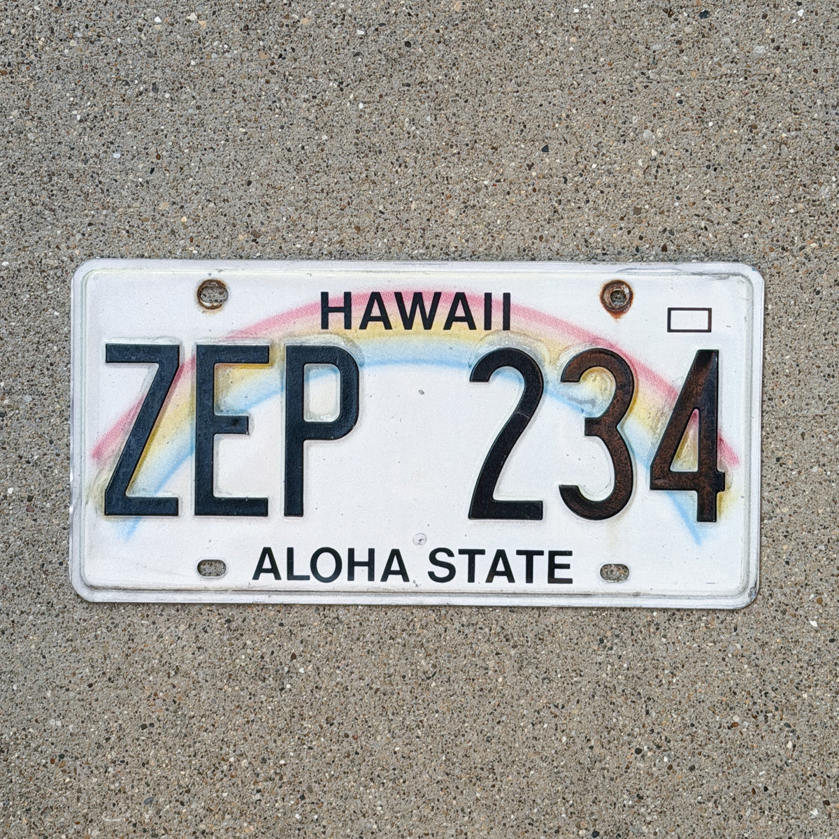 Photo of a 1990 Hawaii License Plate Auto Tag Garage Decor Vintage Rainbow ZEP 234 with original patina