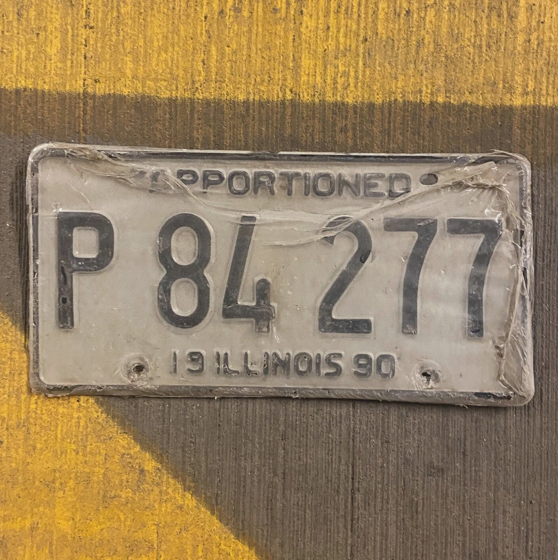 Photo of a 1990 Illinois Apportioned License Plate Auto Tag Garage New Old Stock P 84277