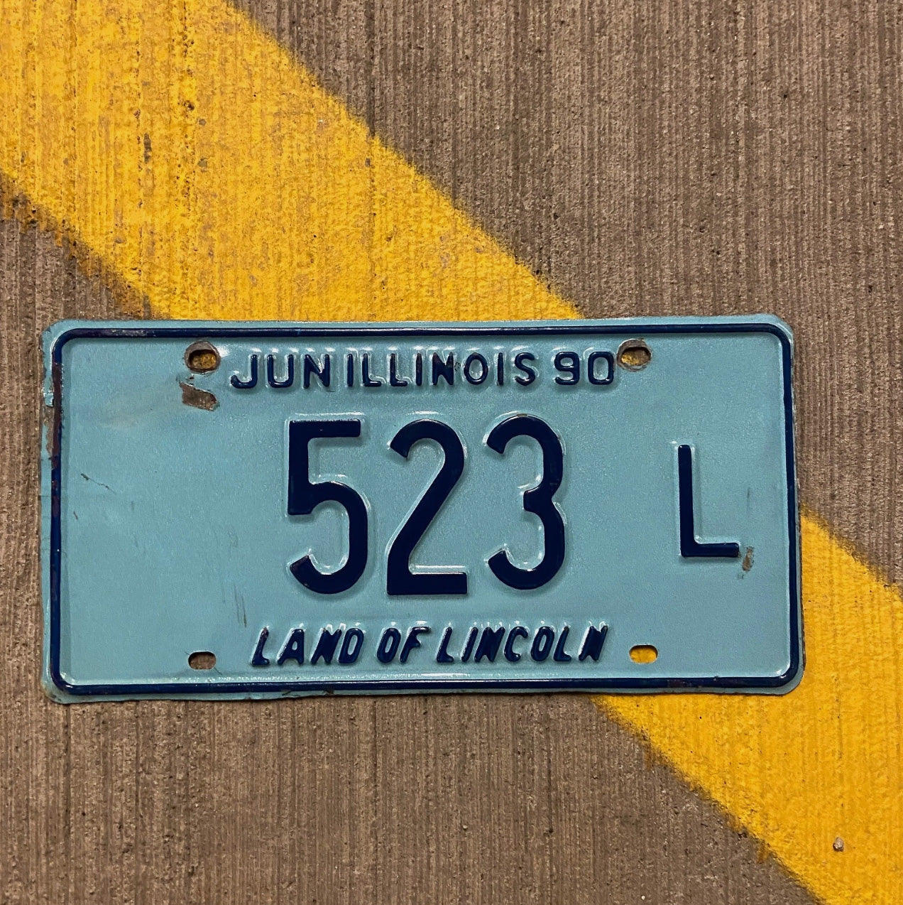 Photo of a 1990 Illinois Truck License Plate Auto Tag Garage Decor Vintage 523 L with original patina