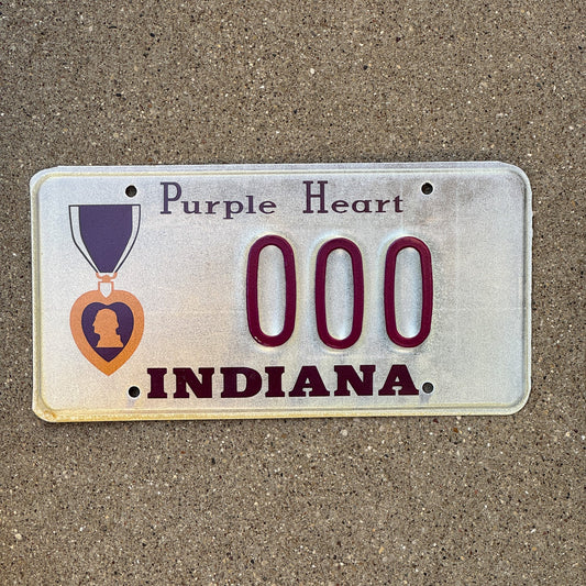 Photo of a 1990 Indiana Sample License Plate Auto Tag Garage Decor Vintage Military Purple Heart 000 with original patina