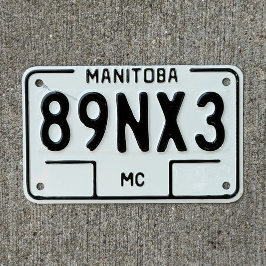 Photo of a 1990 Manitoba Motorcycle License Plate Auto Tag Garage Decor Vintage 89 NX 3 with original patina