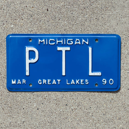 Photo of a 1990 Michigan Vanity License Plate Auto Tag Garage Decor Vintage Praise the Lord PTL with original patina