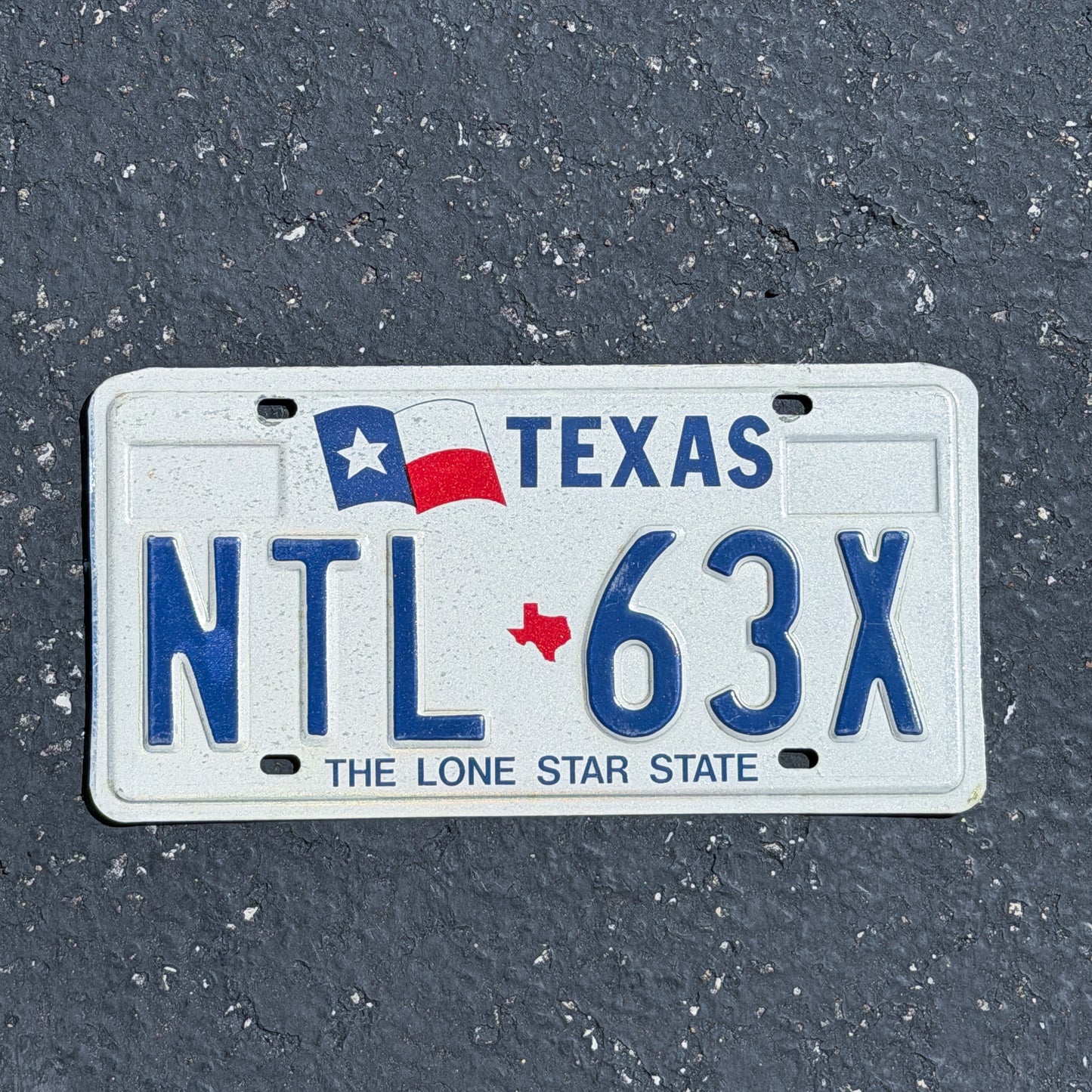 Photo of a 1990 Texas License Plate Auto Tag Garage Decor Vintage NTL 63X with original patina
