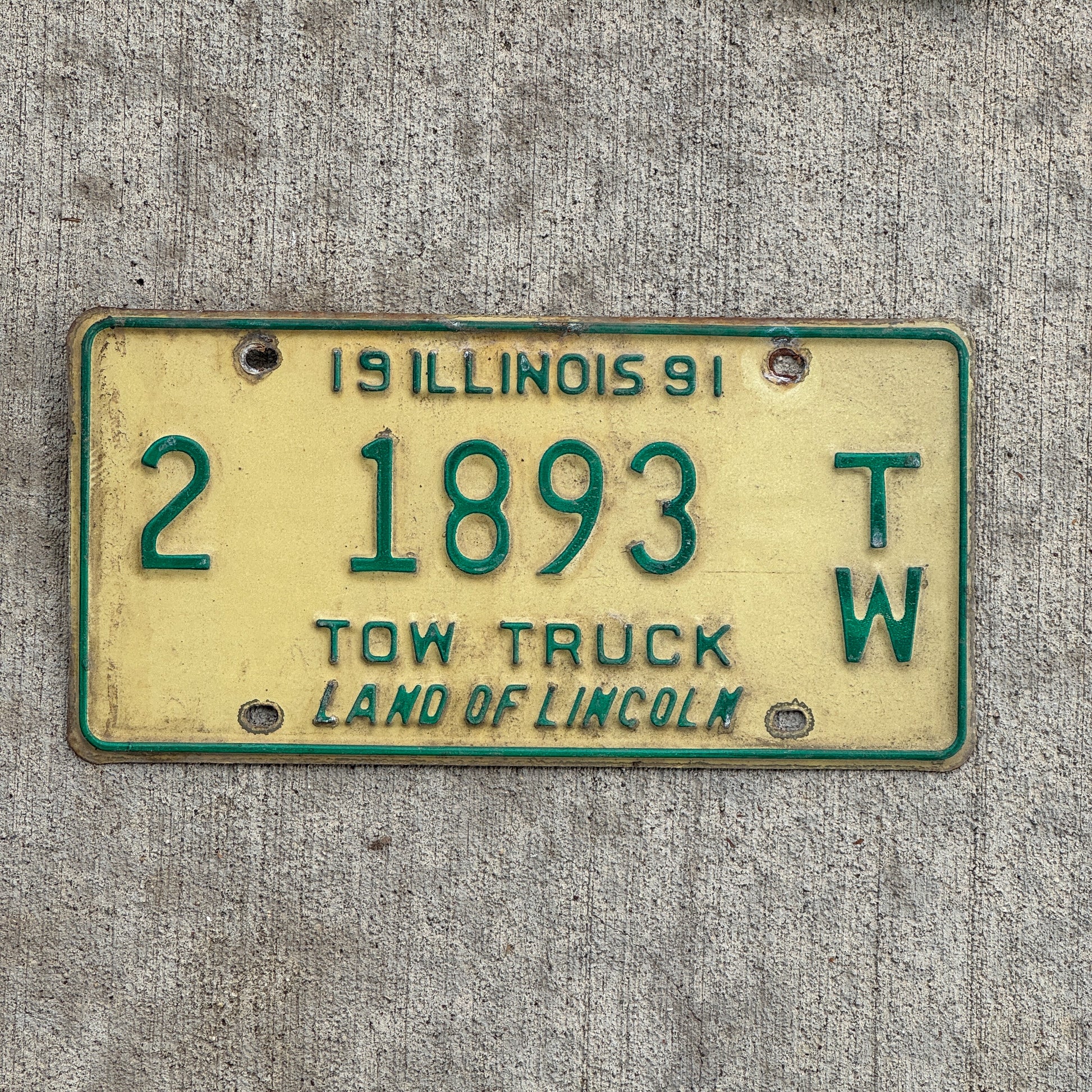Photo of a 1991 Illinois Tow truck License Plate Auto Tag 2 Vintage Garage 2 1893 TW with original patina