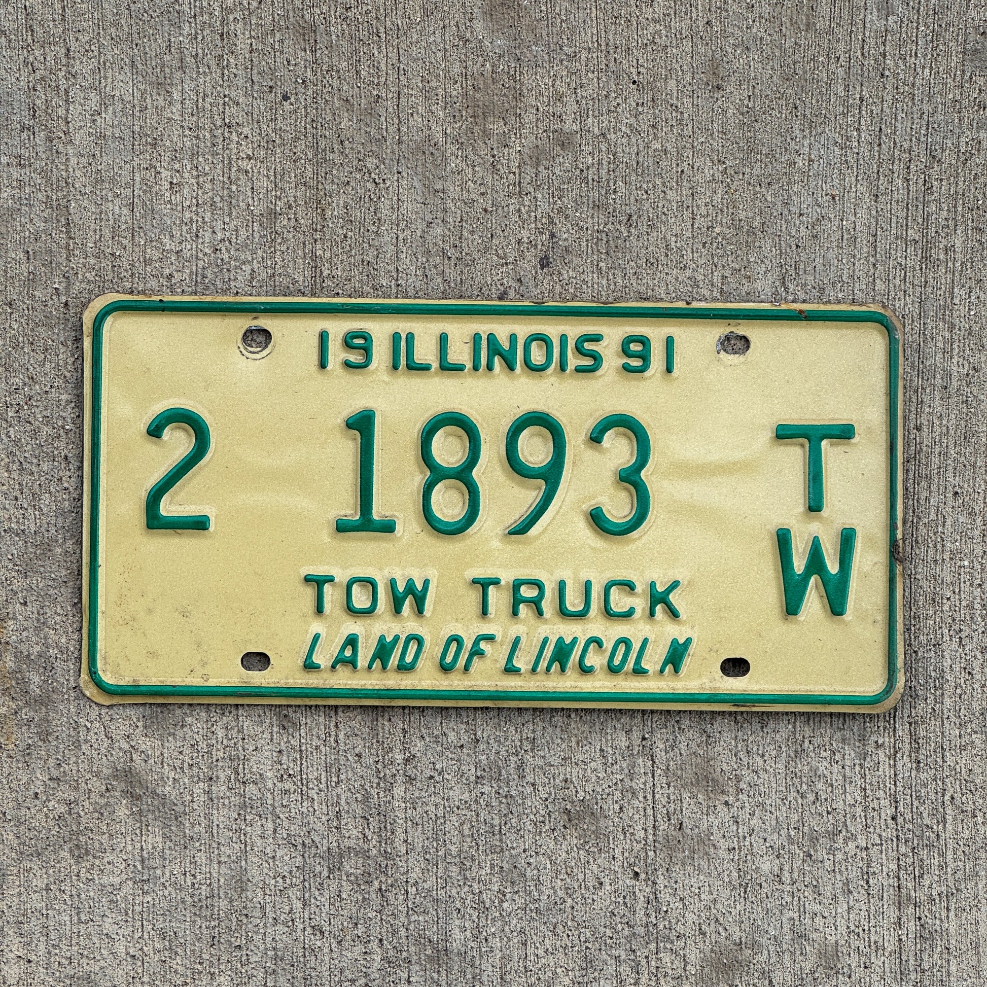 Photo of a 1991 Illinois Tow truck License Plate Auto Tag Garage Decor Vintage 2 1893 TW with original patina