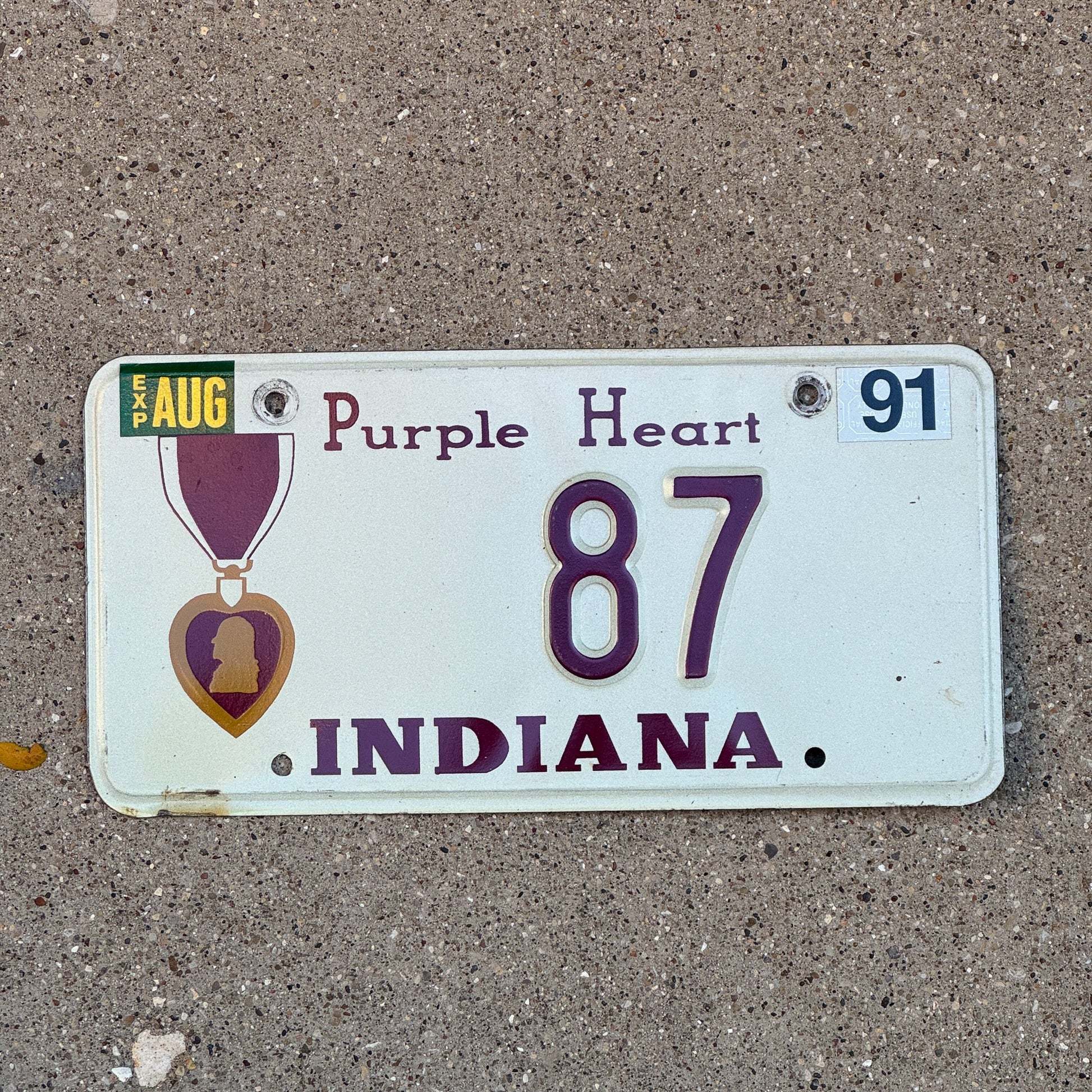 Photo of a 1991 Indiana Military License Plate Auto Tag Garage Decor Vintage Purple Heart 87 with original patina