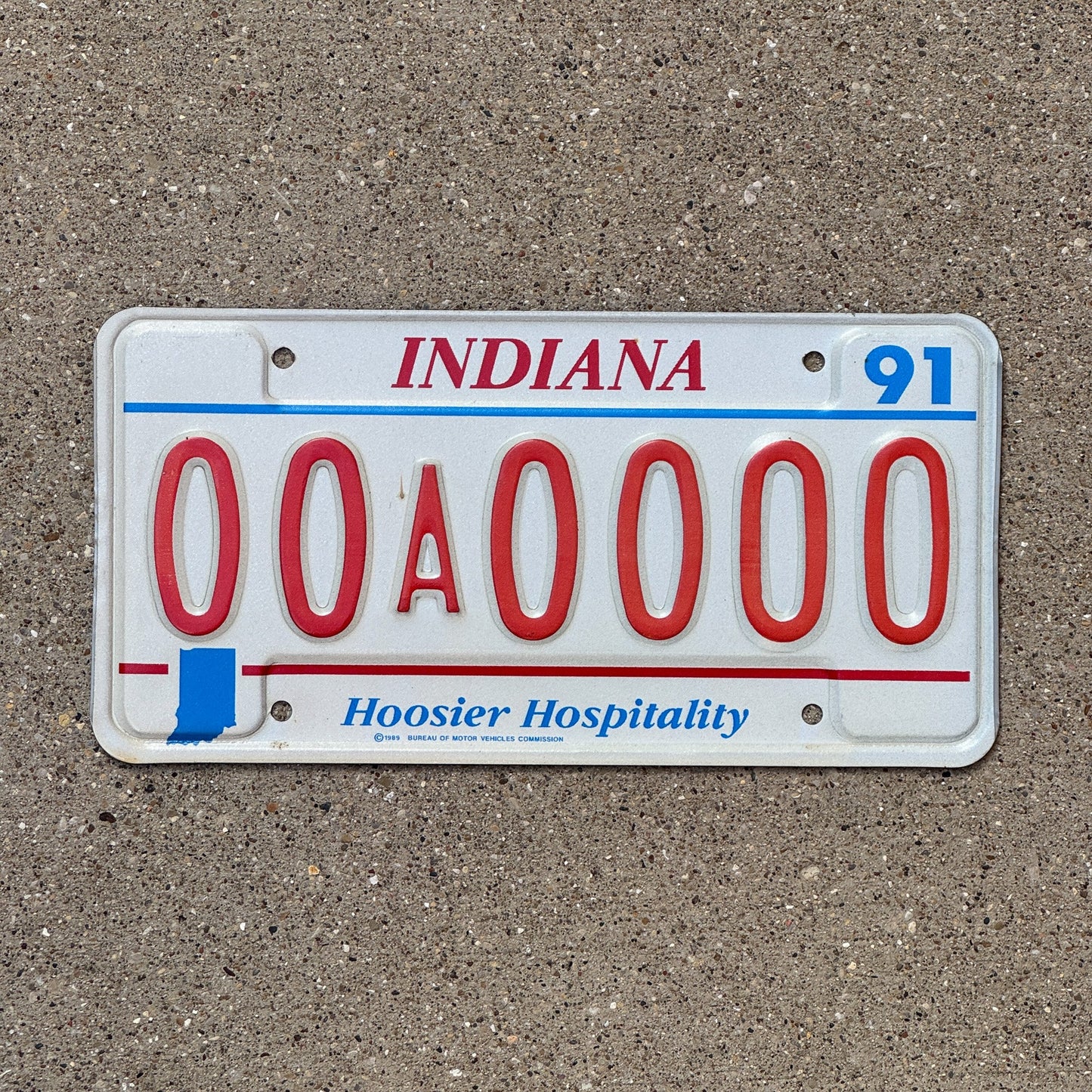 Photo of a 1991 Indiana Sample License Plate Auto Tag 4 Vintage 00A0000 with original patina