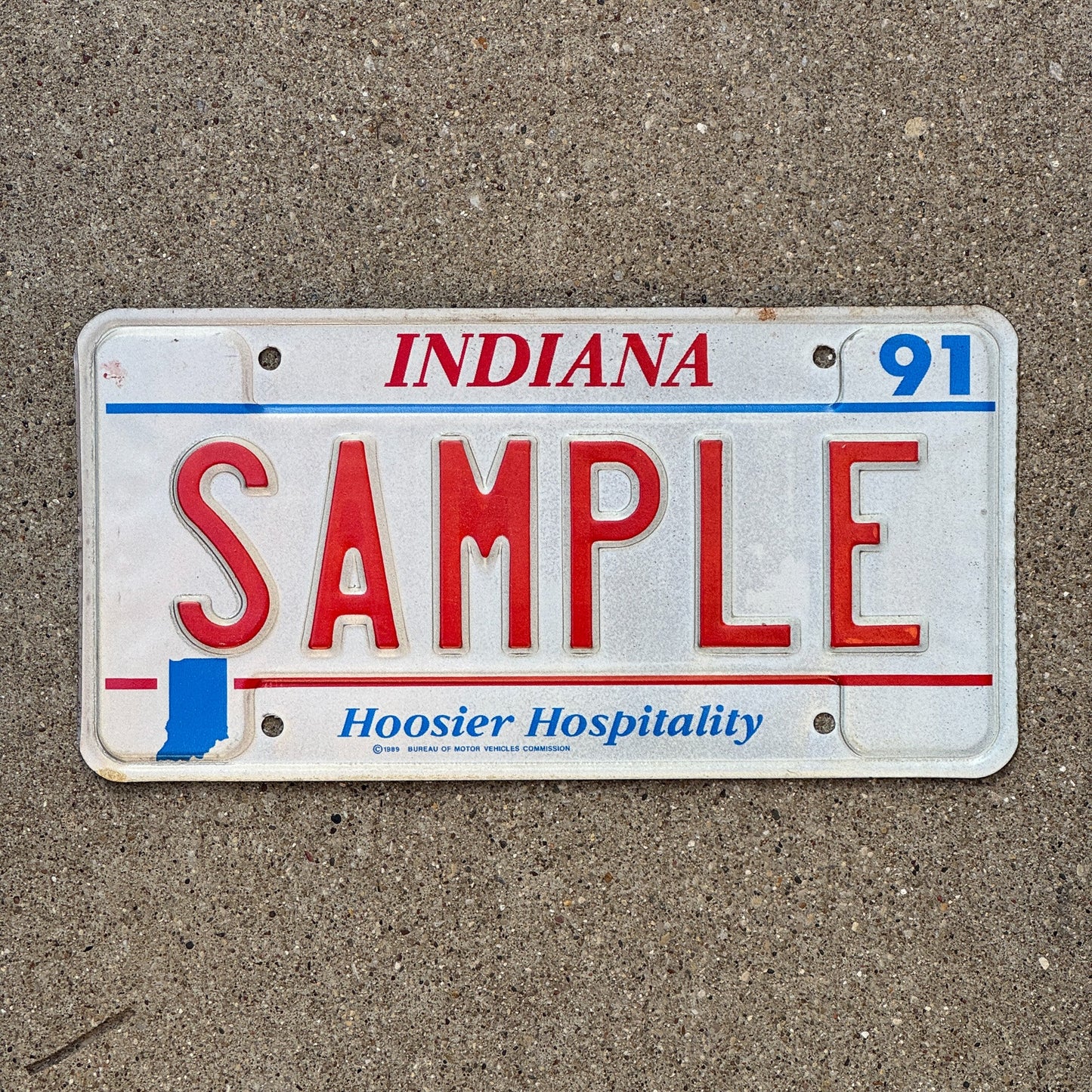 Photo of a 1991 Indiana Sample License Plate Auto Tag Garage Decor Vintage SAMPLE with original patina