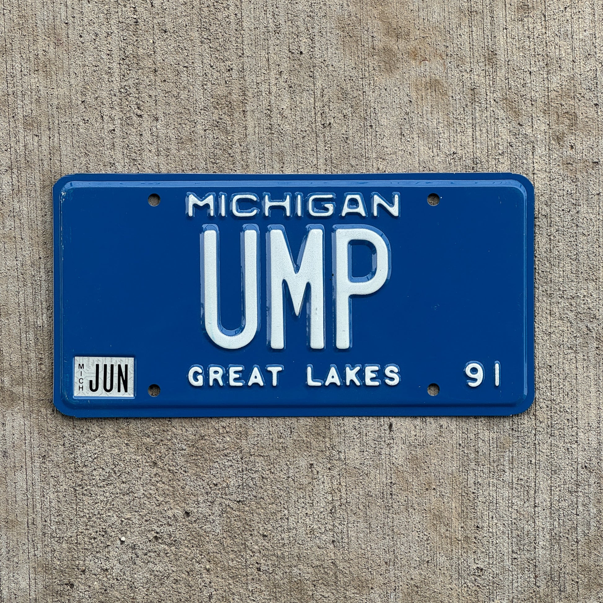 Photo of a 1991 Michigan Vanity License Plate Auto Tag Garage Decor Vintage Umpire Baseball Fan Gift UMP with original patina