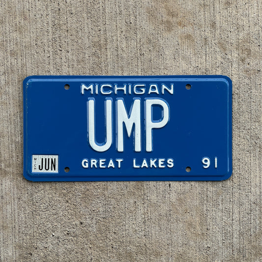 Photo of a 1991 Michigan Vanity License Plate Auto Tag Garage Decor Vintage Umpire Baseball Fan Gift UMP with original patina