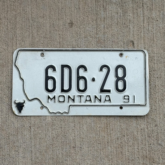 Photo of a 1991 Montana Dealer License Plate Auto Tag Garage Decor Vintage State Shape 6D6 28 with original patina