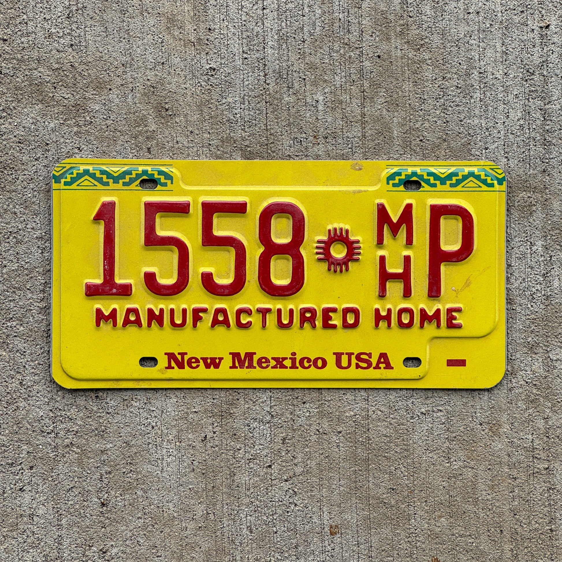 Photo of a 1992 New Mexico Manufactured home License Plate Auto Tag Garage Decor Vintage 1558 MH P with original patina