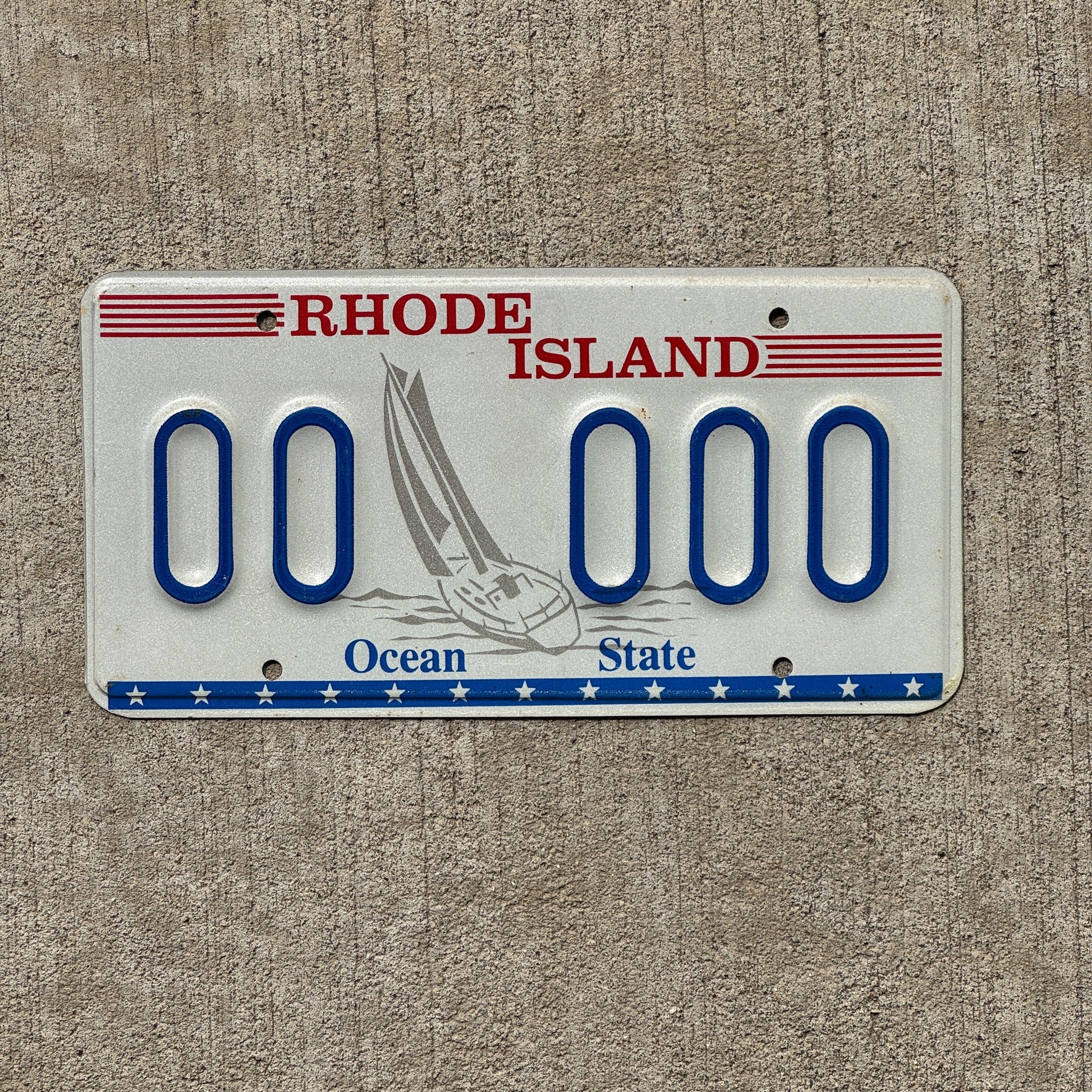 Photo of a 1992 Rhode Island Graphic Sample License Plate Auto Tag Garage Decor Vintage Designor Sailboat Base 00 000