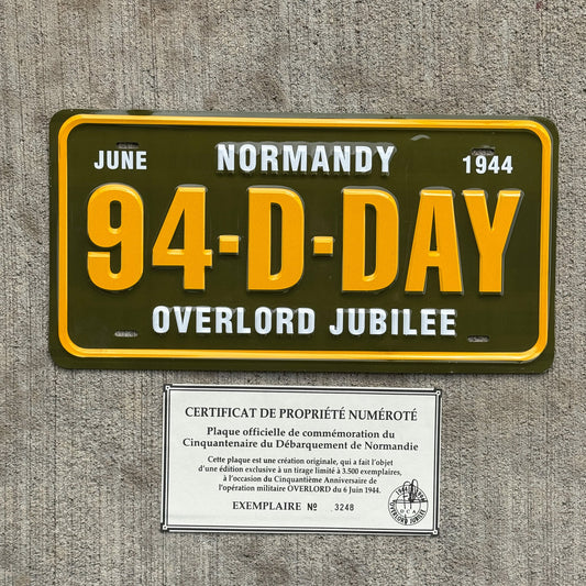 Photo of a 1994 Booster License Plate Auto Tag Garage Decor Vintage WWII Normandy 50th Anniversary 94 D DAY with original patina