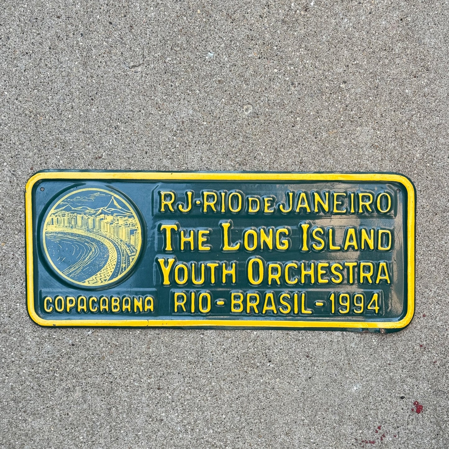 Photo of a 1994 Brazil License Plate Auto Tag Garage Decor Vintage Rio de Janiero Copacabana Oversized Commemorative Long Island Youth Orchestra with original patina