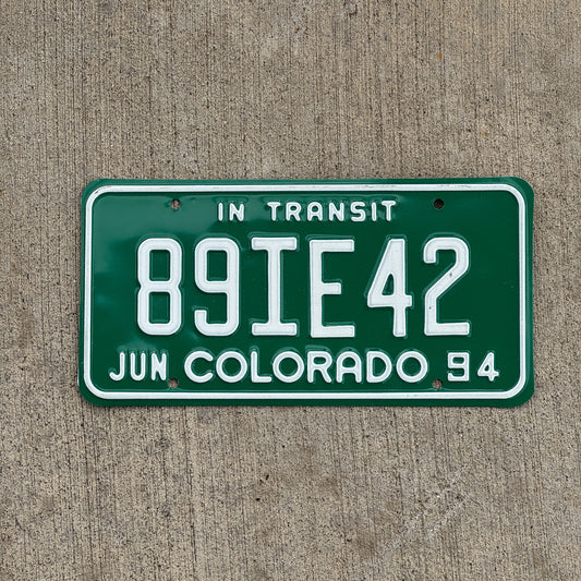 Photo of a 1994 Colorado In Transit Dealer License Plate Auto Tag Garage Decor Vintage 89 IE 42 with original patina