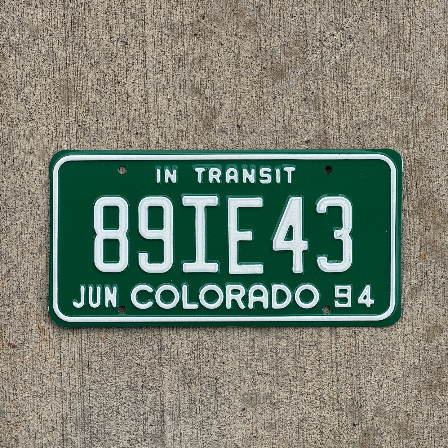 Photo of a 1994 Colorado In Transit Dealer License Plate Auto Tag Garage Decor Vintage 89 IE 43 with original patina