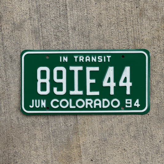 Photo of a 1994 Colorado In Transit Dealer License Plate Auto Tag Garage Decor Vintage 89 IE 44 with original patina