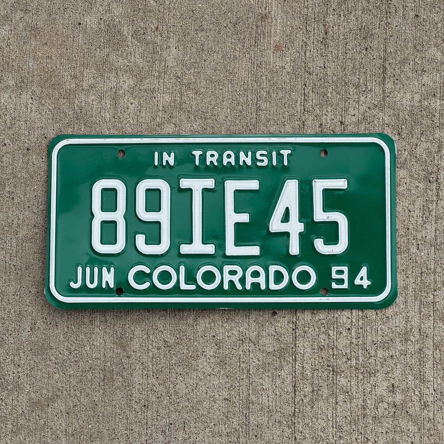 Photo of a 1994 Colorado In Transit Dealer License Plate Auto Tag Garage Decor Vintage 89 IE 45 with original patina